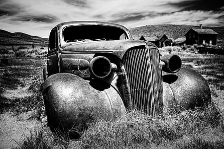 grayscale photo of abandoned car