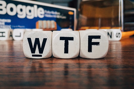 WTF word boggle blocks on brown wooden surface