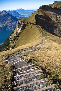 person walking on the mountain during daytime