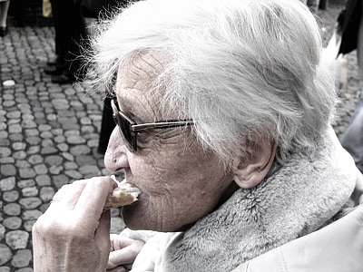 woman eating bread close-up photo