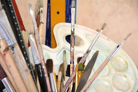 assorted paint brushes in shallow focus photography