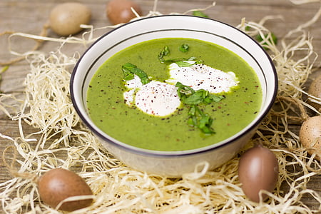 green soup in a white bowl