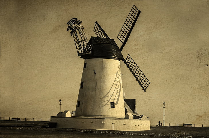 white windmill beside shore