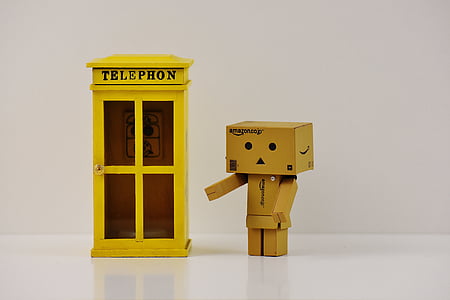 box figurine standing near telephone booth