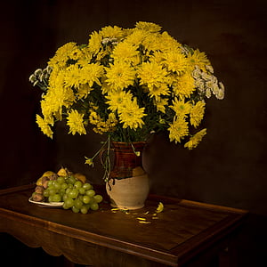 yellow flowers centerpiece with beige and brown ceramic vase