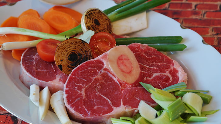 raw meat with spring onions and sliced carrots