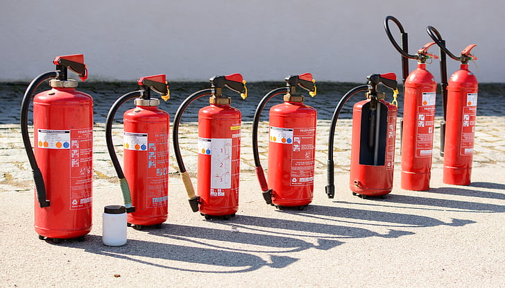 seven fire extinguisher on seashore