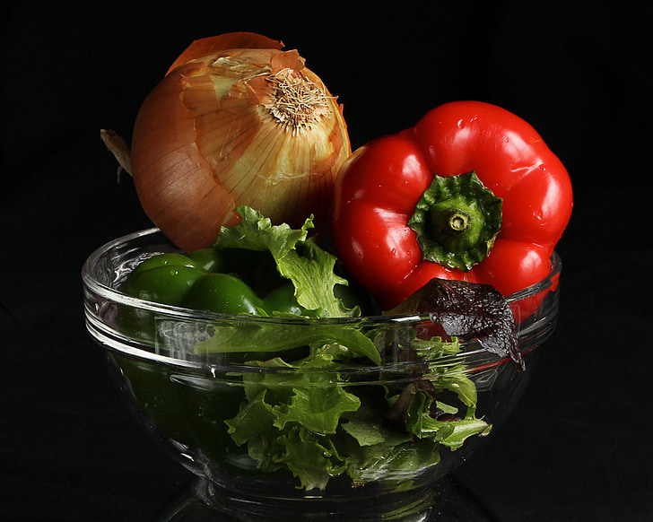 onion and chili pepper on clear glass bowl