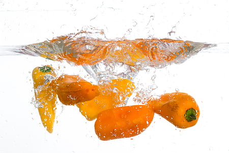 orange bell peppers in body of water