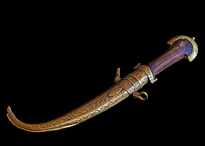 brass-colored jambi knife