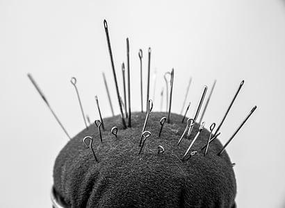 selective focus photography of pins in pin cushion