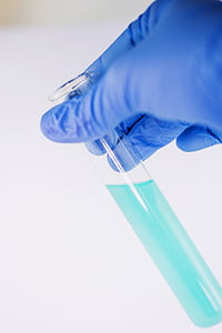 shallow focus photography of cyan liquid filled test tube