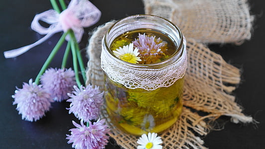 clear glass jar with chives and camomile