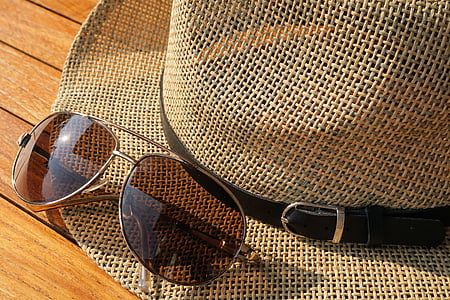 photo of sunglasses on top of hat