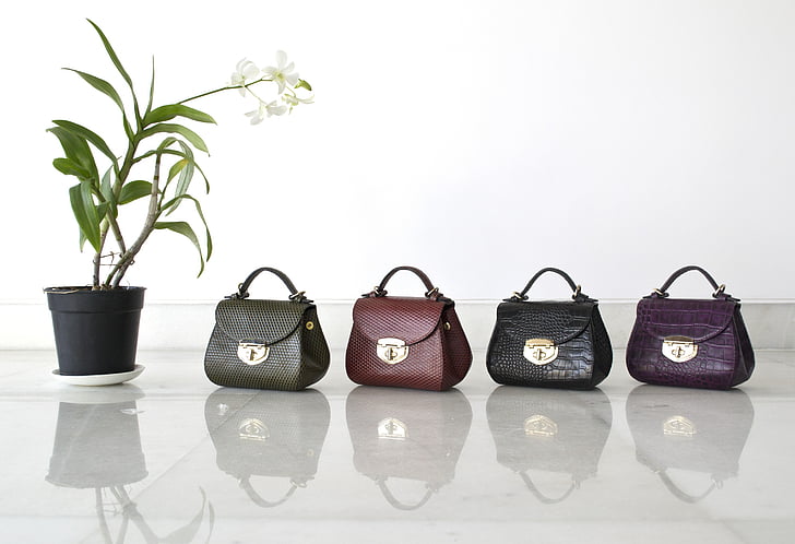 four assorted-color leather handbags