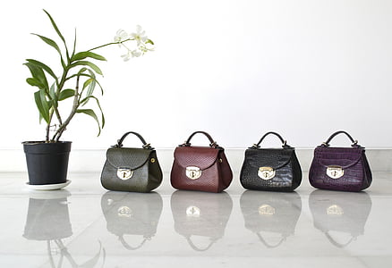 four assorted-color leather handbags