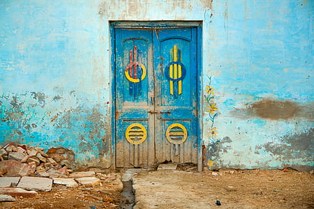 blue wooden door with blue painted concrete wall