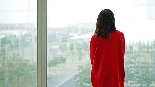 woman standing near glass window