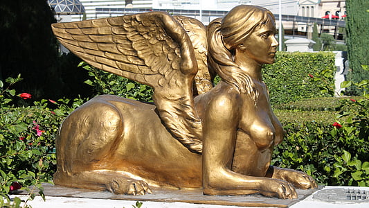 photo of brass sculpture during daytime