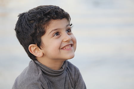 selective focus photography of a smiling kid