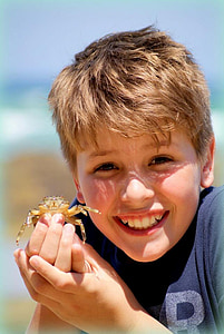 boy holding brown crab