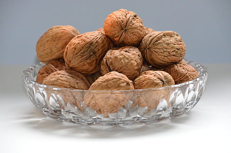 photo of chestnuts on top of clear glass bowl