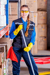 woman in blue vest wearing yellow gloves