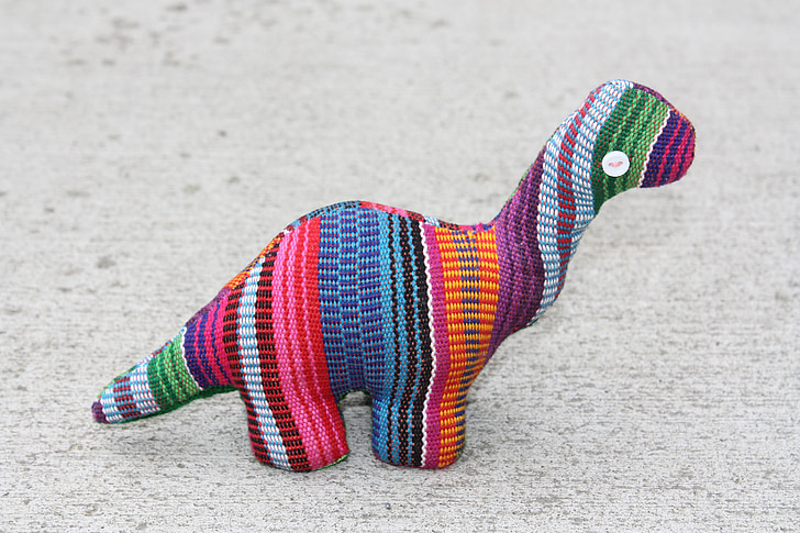 multicolored dinosaur plush toy