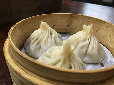 three dumplings in brown container