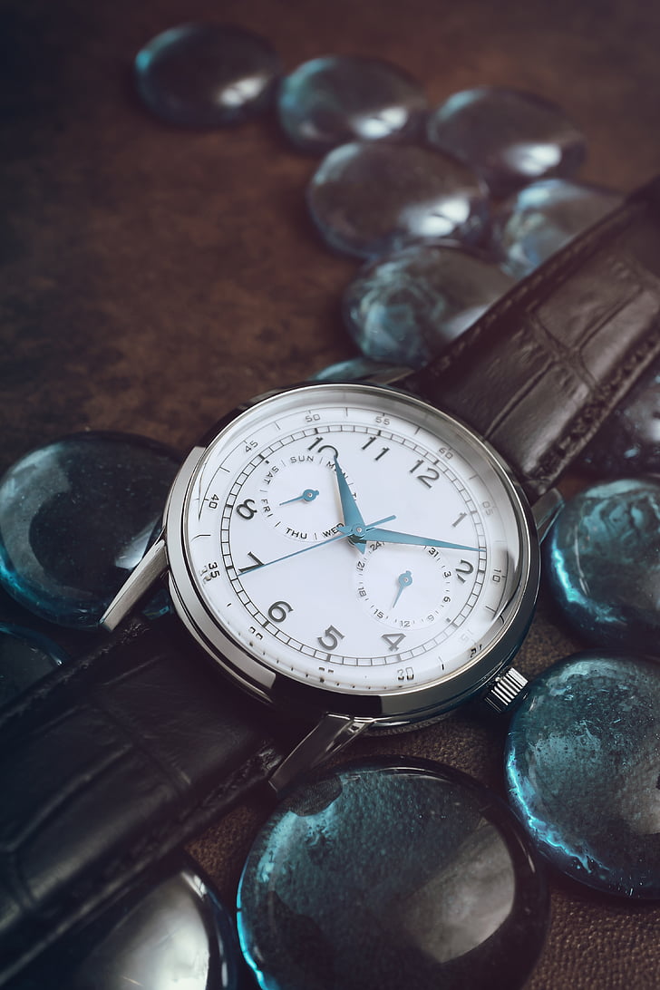 round silver-colored analog watch at 10:09