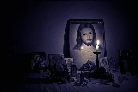 taper candle behind Jesus Christ photo