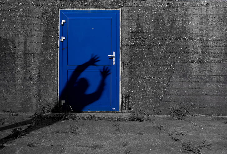 person's shadow on door