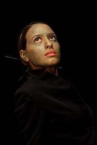 woman wears black collared top