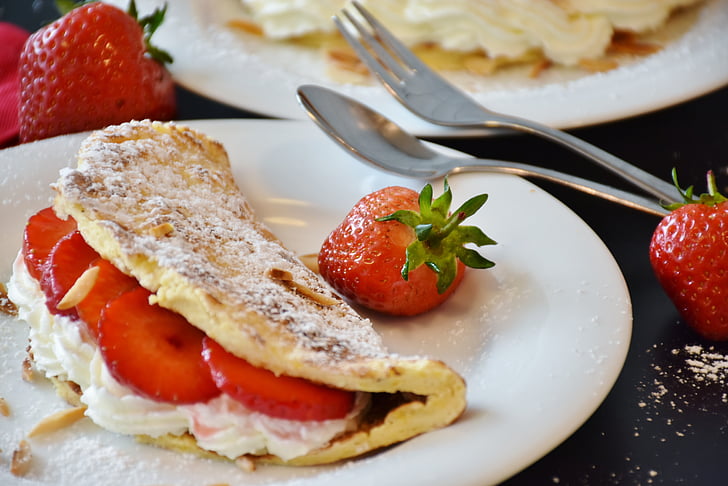 white flat bread with strawberries on top of white plate