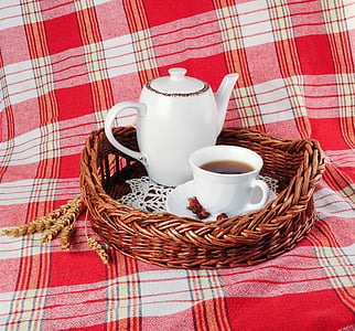 white ceramic teapot and cup of coffee on brown wicker tray