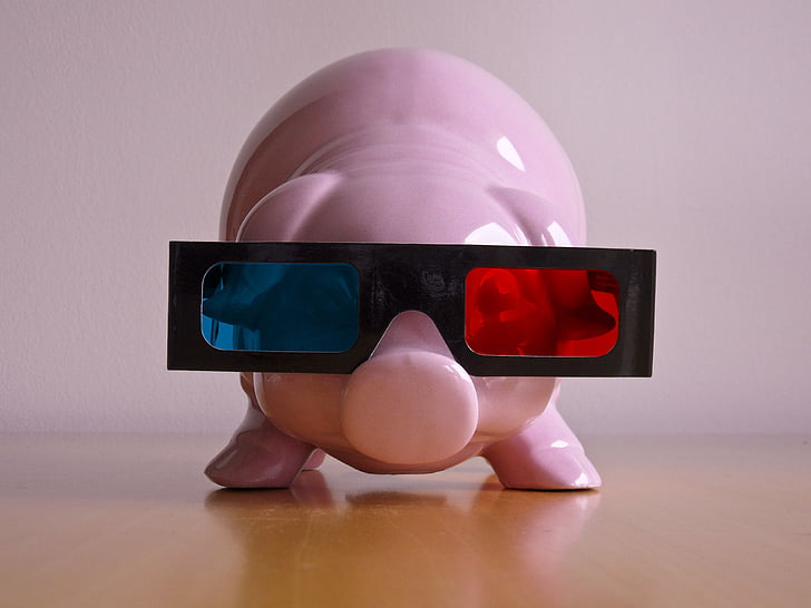 pink ceramic coin bank wearing blue, red, and black 3D glasses