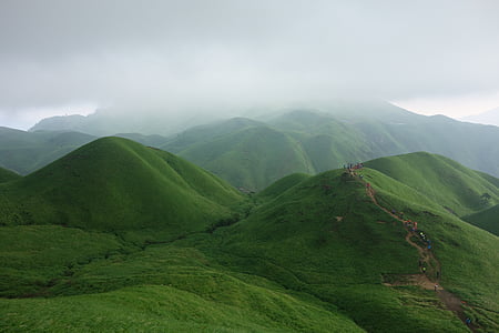 green hills under nimbus clouds