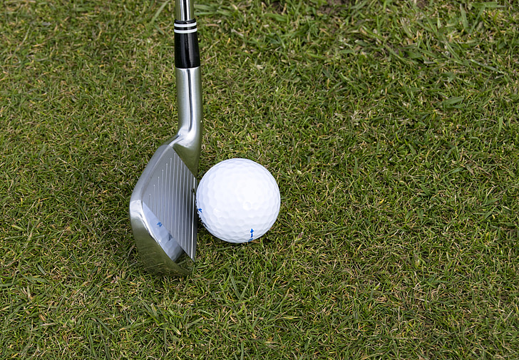 golf wedge beside golf ball