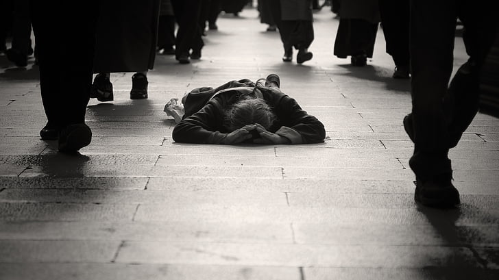 man lying on floor during daytime