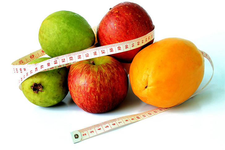 variety of fruits with tape measure