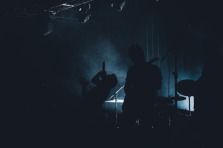 silhoutte of men playing musical instruments