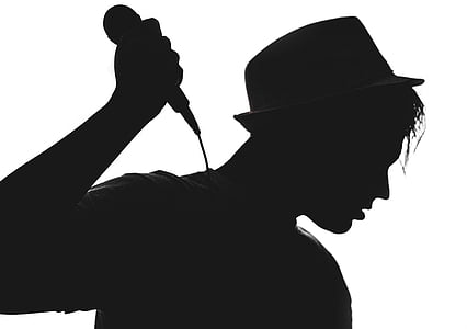 silhouette of man holding microphone
