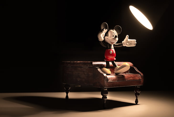 Mickey Mouse figure standing on grand piano miniature