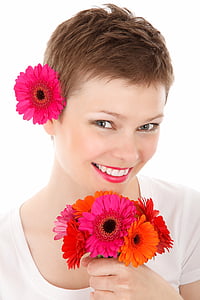 women's in white top holding flowers