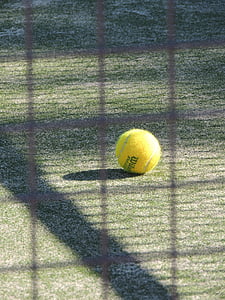 yellow Wilson tennis ball on green grass