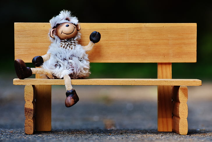 monkey doll sitting on bench