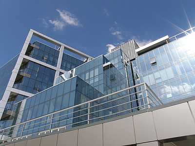 clear glass and gray concrete building in low angle photography