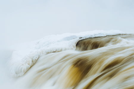 river on snowy mountain time lapsed photography