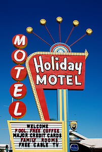 Holiday Motel neon sign under calm sky