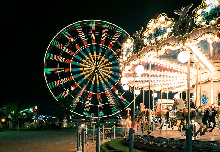 ferris wheel and carousel at night
